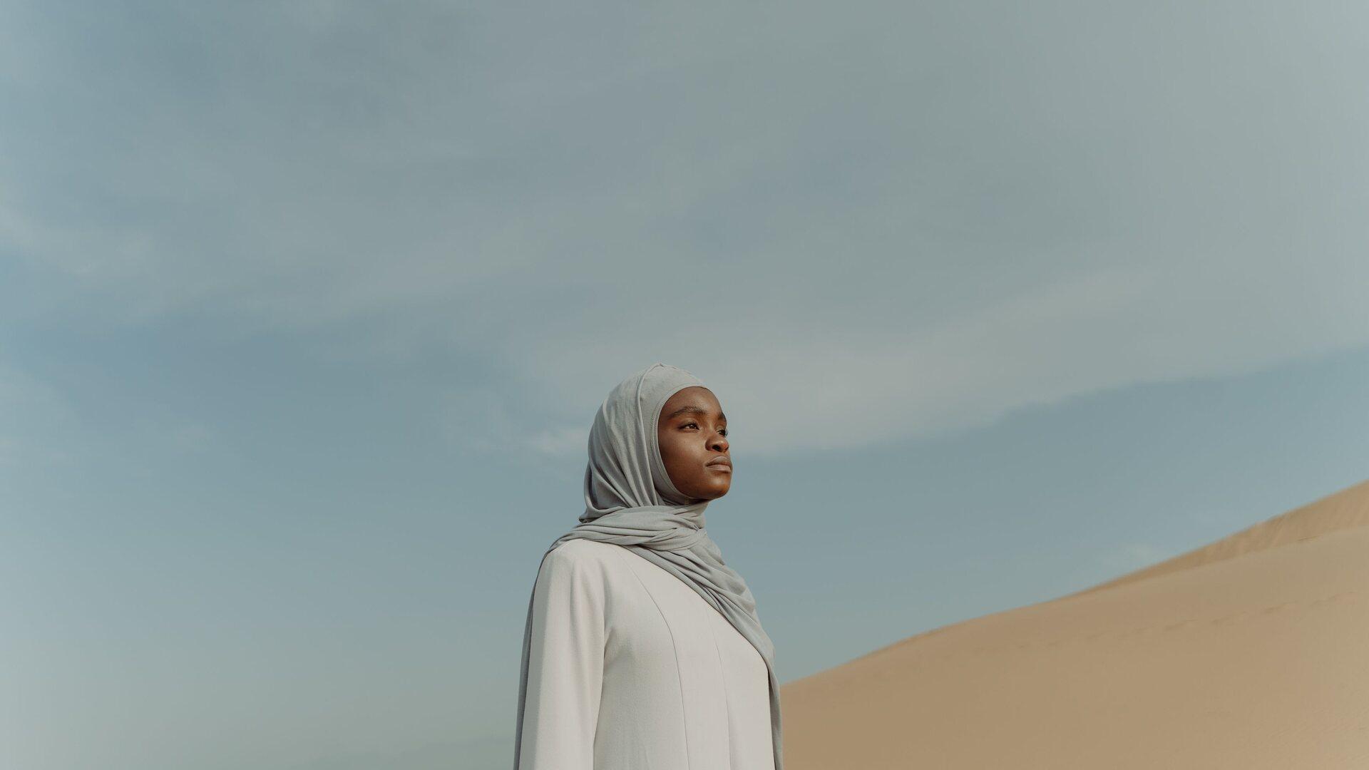 Young African woman with headscarf posing in the desert
