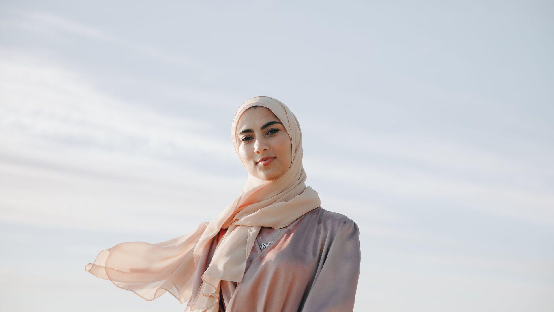 Young woman with headscarf posing mid shot into camera