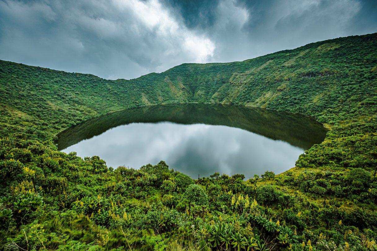 Lake in volcano crater surrounded by vegetation