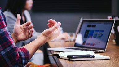 People in a meeting with using hands to communicate 