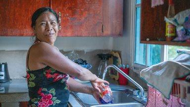 Señora Granadilla doing the dishes in her home in Honduras