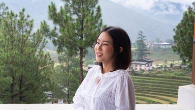 Woman smiling at scenic mountain view in Bhutan