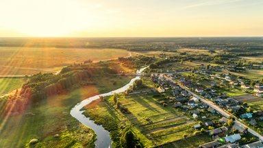 Aerial view. Small european village. Blue winding river