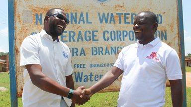 Michael Tumubwine, Area Manager for National Water and Sewerage Corporation in Kijura Sub-county in Kabarole  District, with Martin Watsisi IRC Uganda Regional WASH Advisor