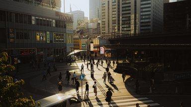 Aerial view of city with people crossing street