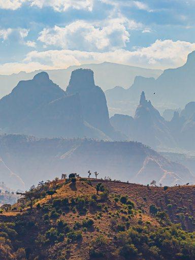 Landscape view with mountains of different size into distance and haze