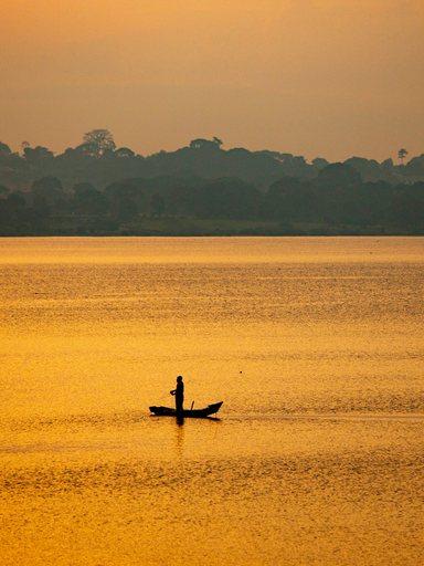 View of river with boats at sunset