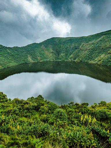 Lake in volcano crater surrounded by vegetation