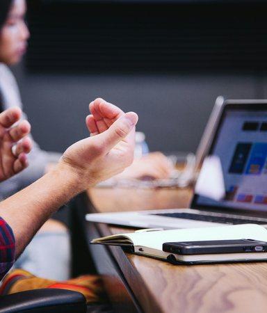 People in a meeting with using hands to communicate 