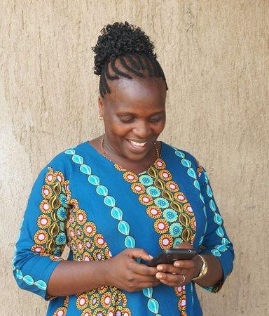 Stella Kewhiba looking at her phone