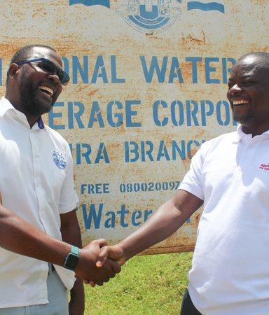 Michael Tumubwine, Area Manager for National Water and Sewerage Corporation in Kijura Sub-county in Kabarole  District, with Martin Watsisi IRC Uganda Regional WASH Advisor