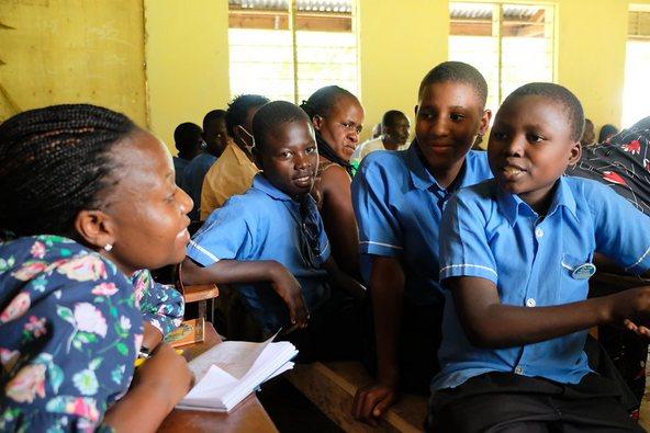Woman visiting school class in Uganda