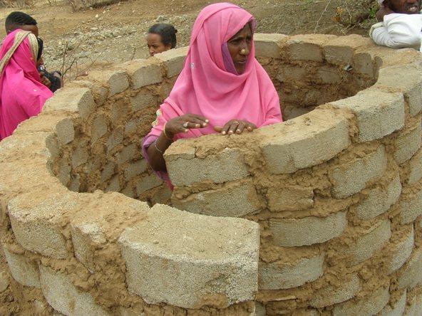 Woman building a latrine in Eritrea