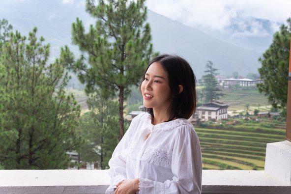 Woman smiling at scenic mountain view in Bhutan