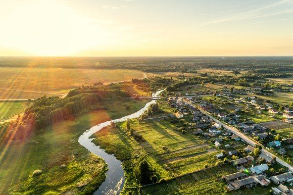 Aerial view. Small european village. Blue winding river