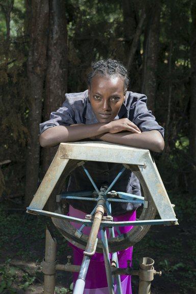 Metike, you woman in Ethiopia leaning on a rope pump