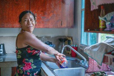 Señora Granadilla doing the dishes in her home in Honduras