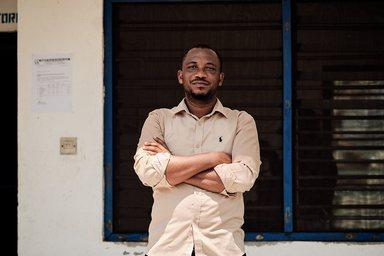 Man folding arms at the Community Water and Sanitation Agency Esiama water system