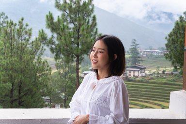 Woman smiling at scenic mountain view in Bhutan