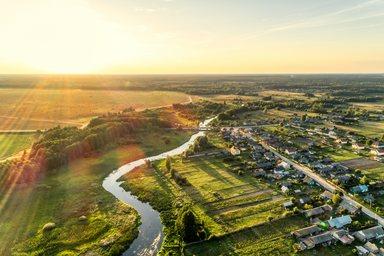 Aerial view. Small european village. Blue winding river