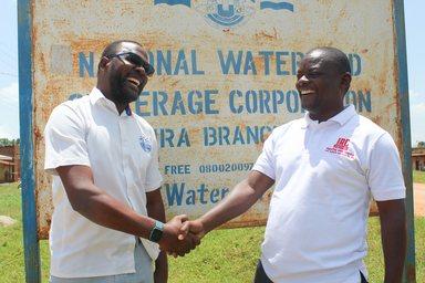 Michael Tumubwine, Area Manager for National Water and Sewerage Corporation in Kijura Sub-county in Kabarole  District, with Martin Watsisi IRC Uganda Regional WASH Advisor