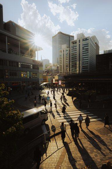 Aerial view of city with people crossing street
