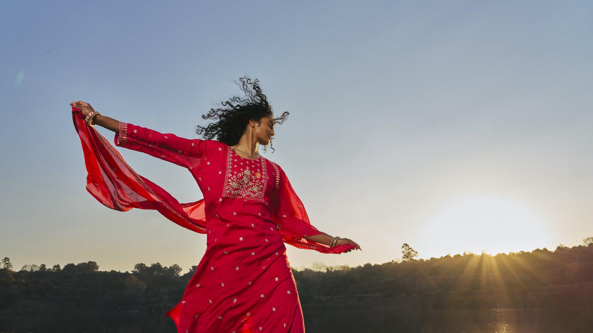 Woman in red dress dancing
