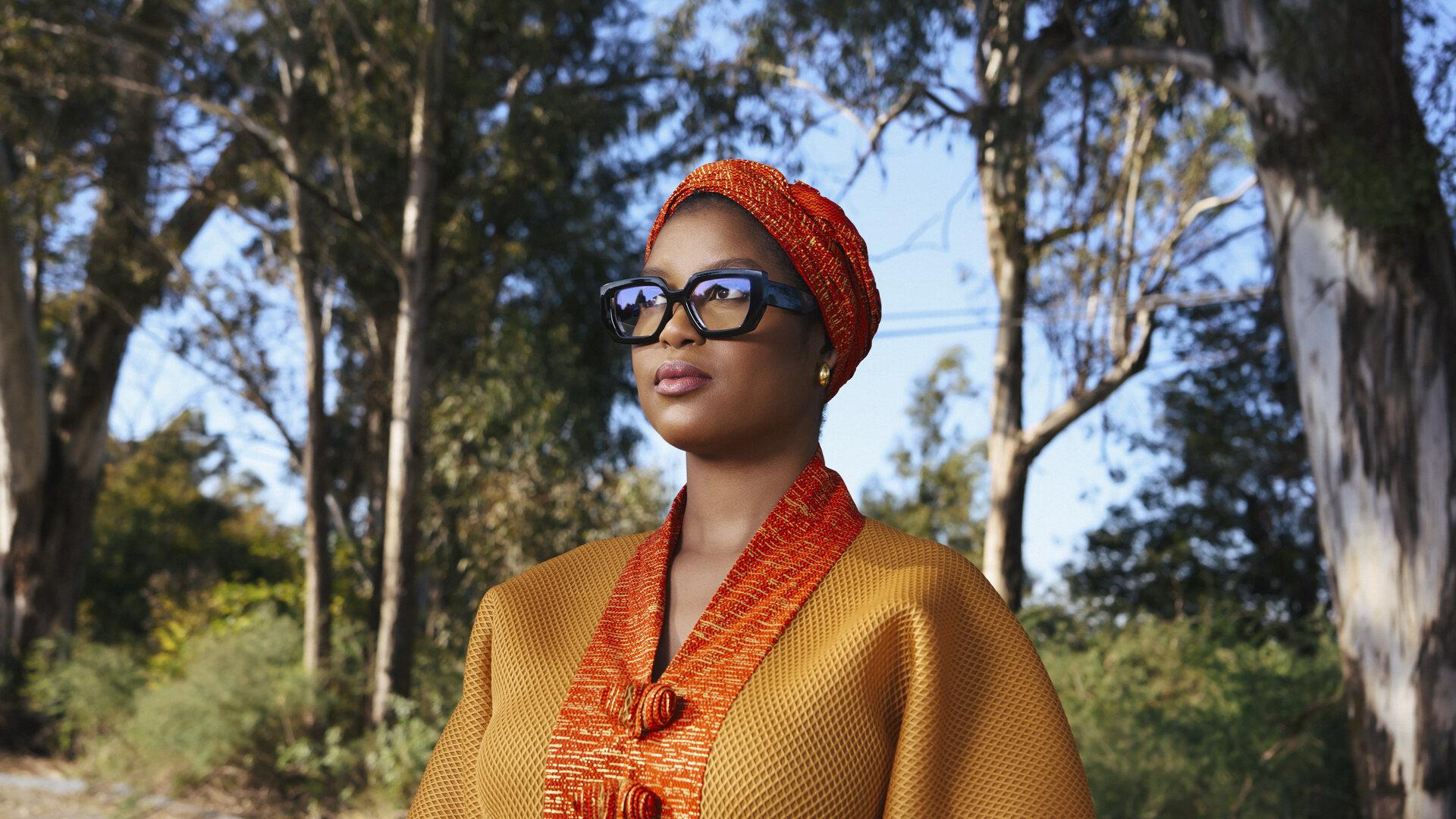 African strong woman with black glasses representing Riva