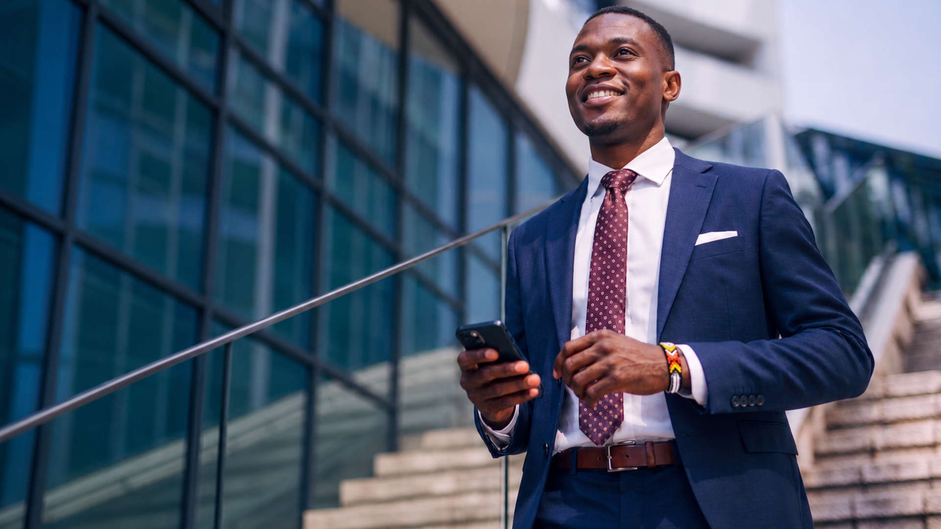 Young African male professional descending from steps