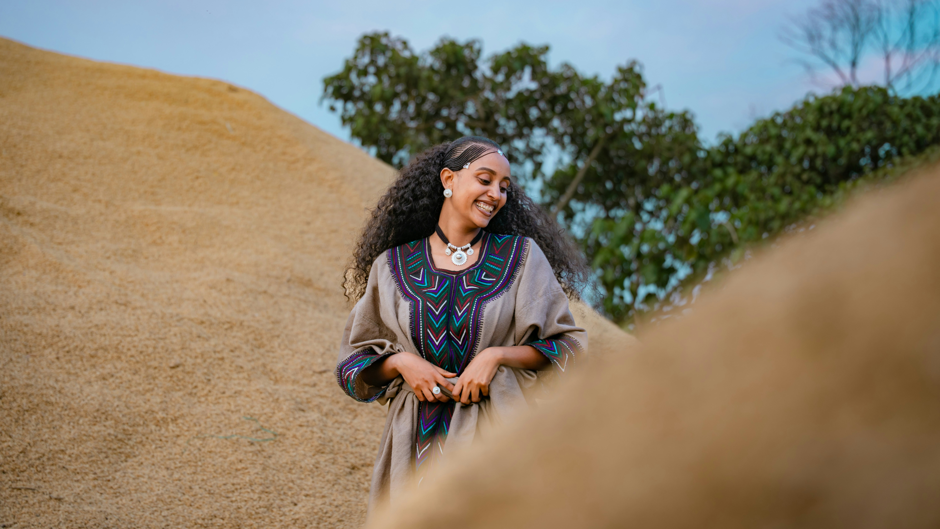 Strong woman in traditional dress smiling outdoors