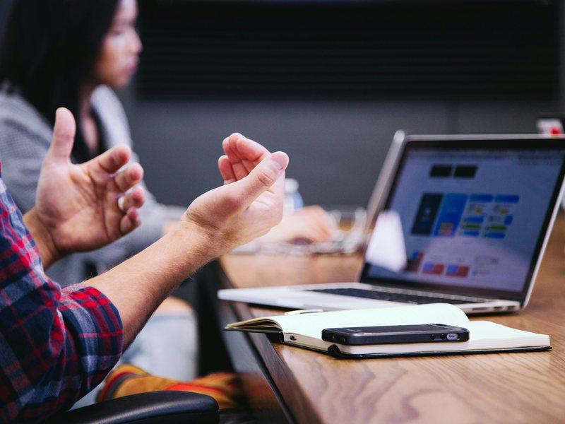 People in a meeting with using hands to communicate