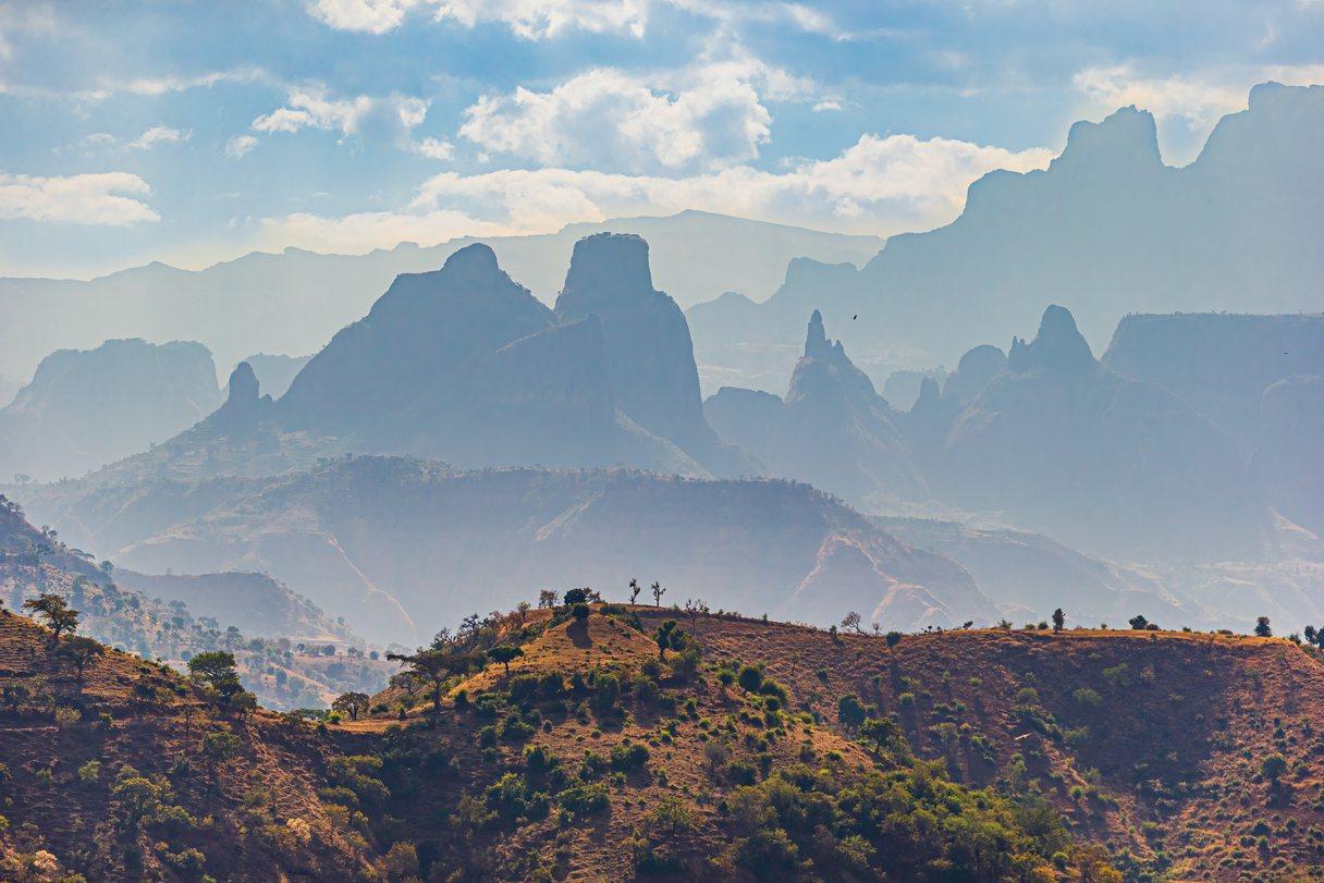 Landscape view with mountains of different size into distance and haze