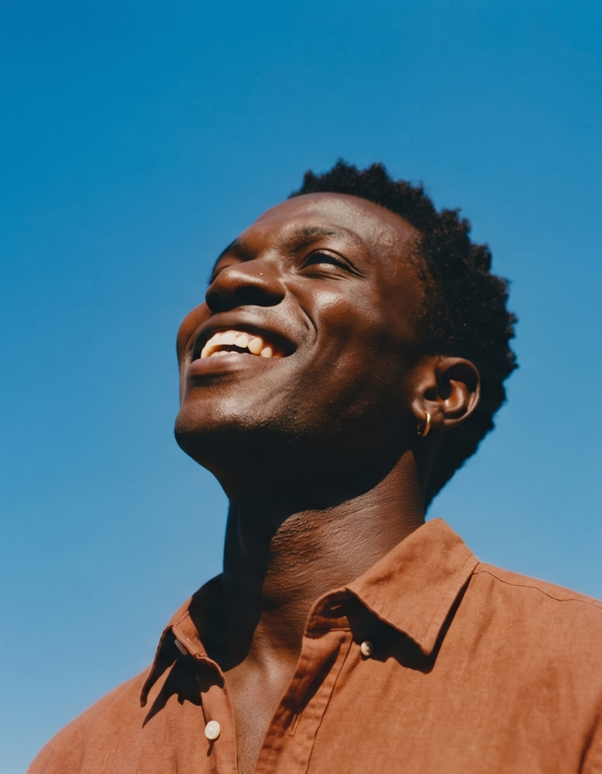Young african man smiling looking to the sky with optimism
