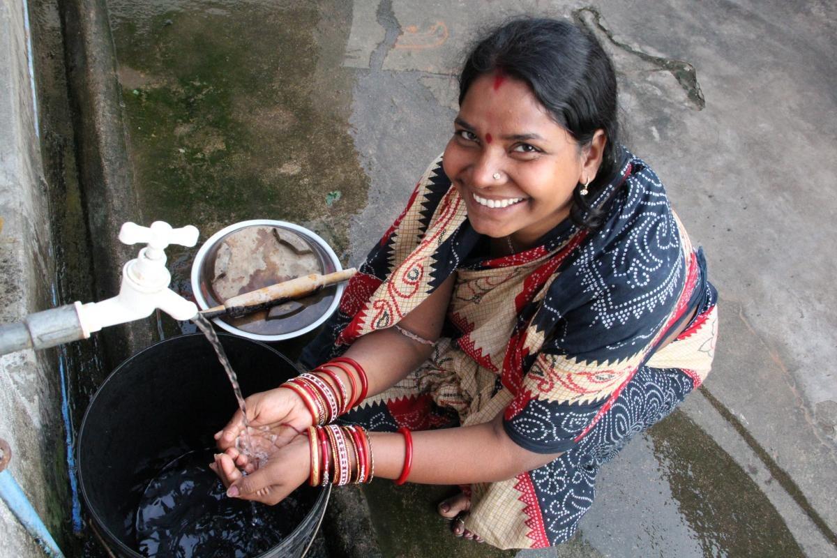woman-fetching-water-smiling