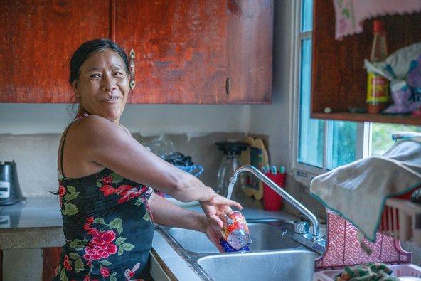 Señora Granadilla doing the dishes in her home in Honduras
