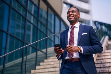 Confident professional looking African man walking down the stairs